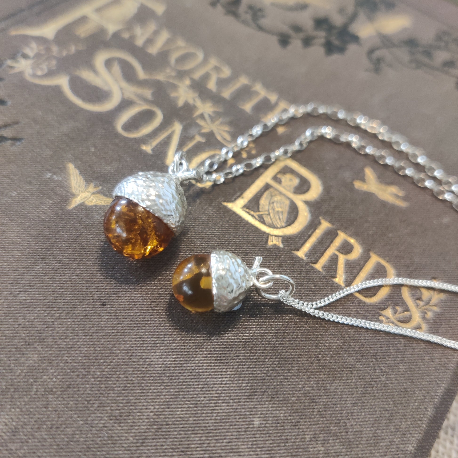 Handcrafted sterling silver and amber pendant necklace.