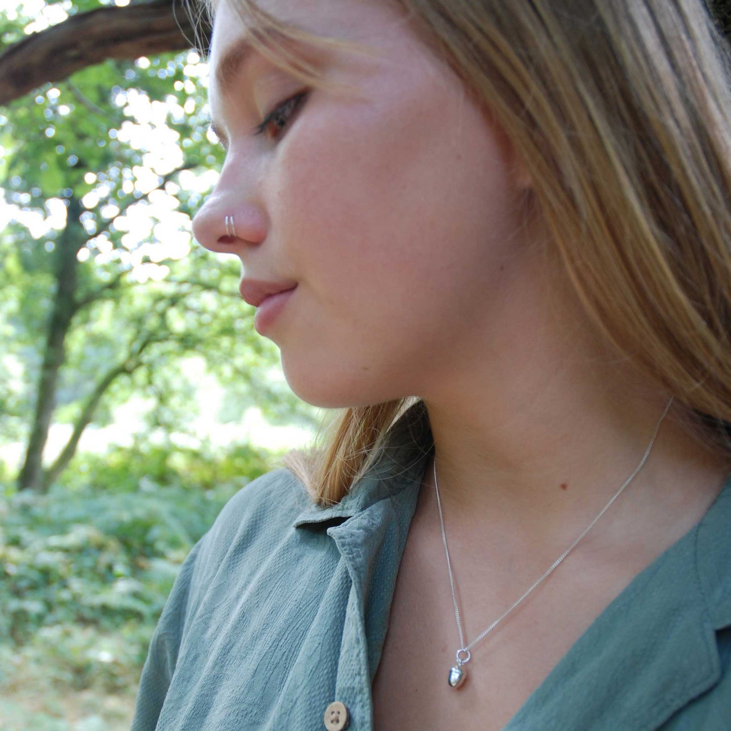 Small acorn pendant on a sterling silver curb chain. 