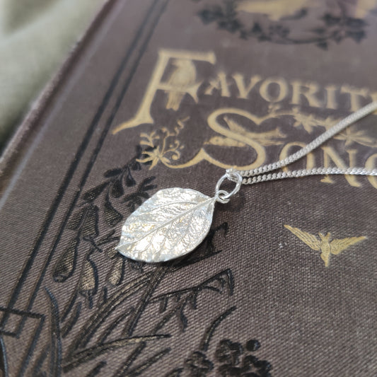 A delicate sterling silver leaf pendant