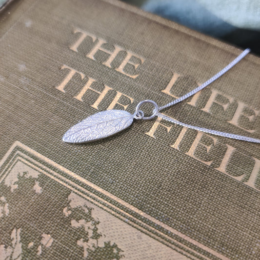 Delicate leaf in sterling silver on a curb chain