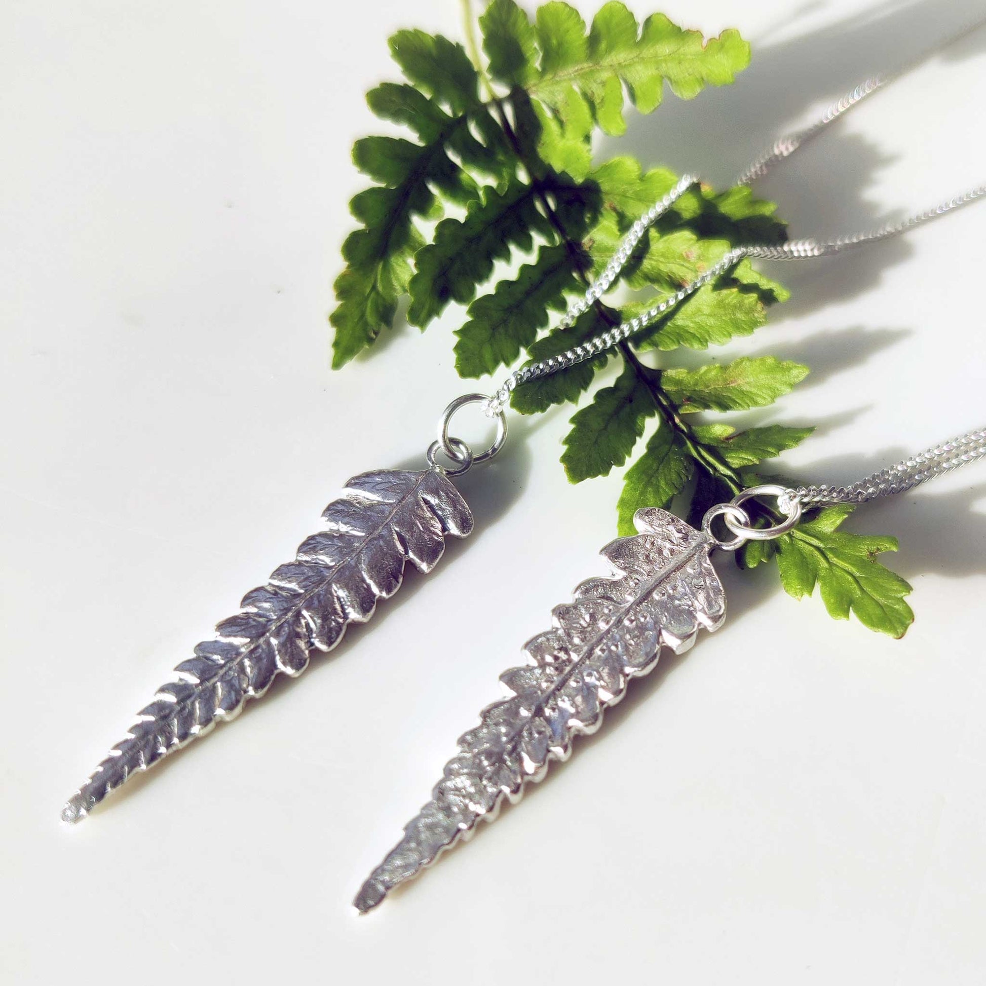 Two sterling silver fern leaf pendants