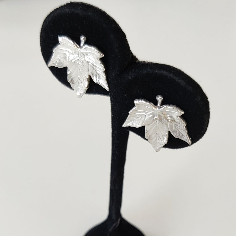 Small eco silver Sycamore leaf stud earrings - on stand