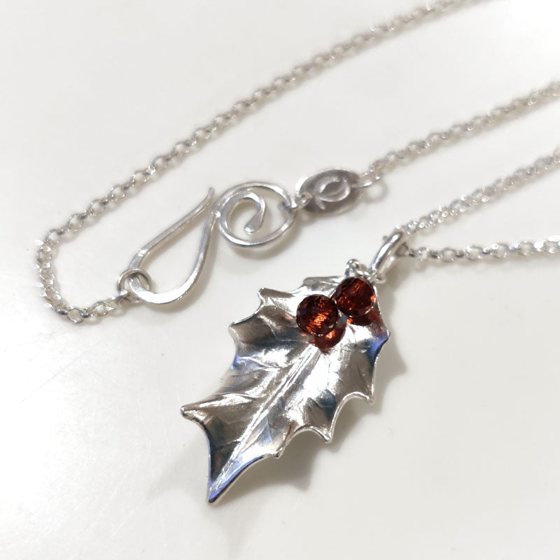 Medium silver holly leaf with Mozambique garnets
