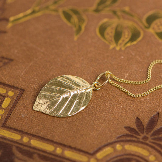 9ct yellow gold pendant cast from a beech leaf by Notional Jewellery