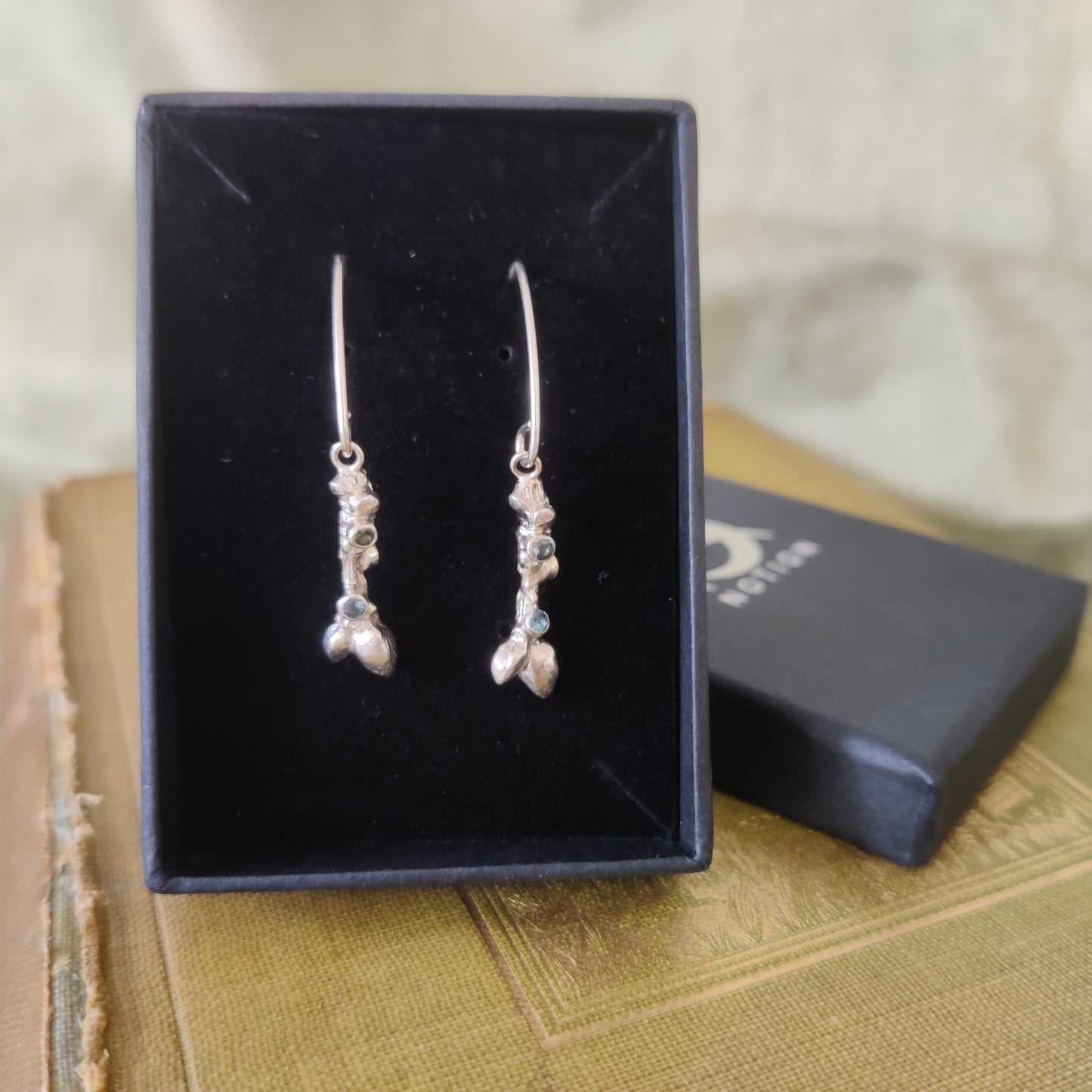 Dangle earrings in silver in a display box by Notion Jewellery