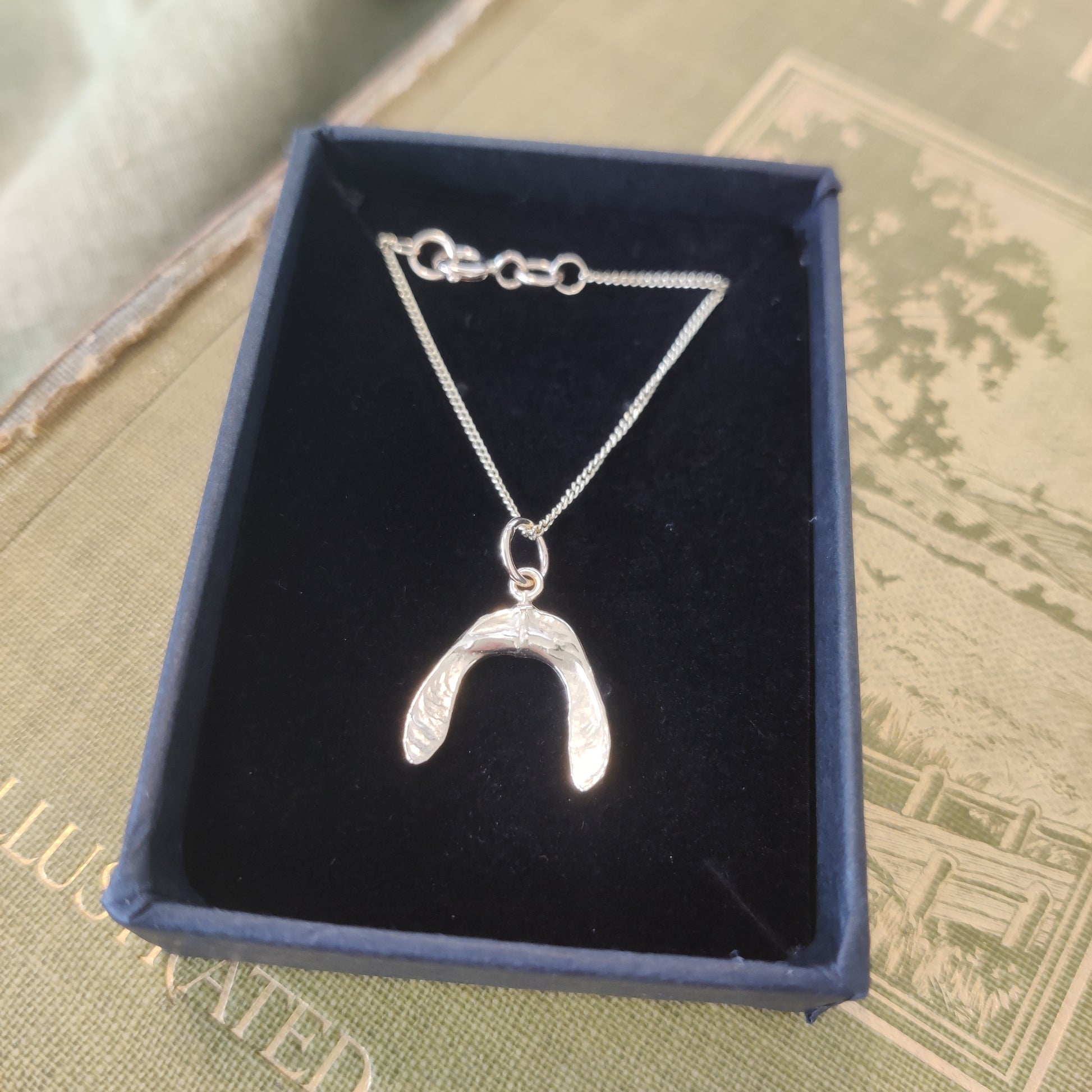 Handmade silver charm necklace by Notion Jewellery.