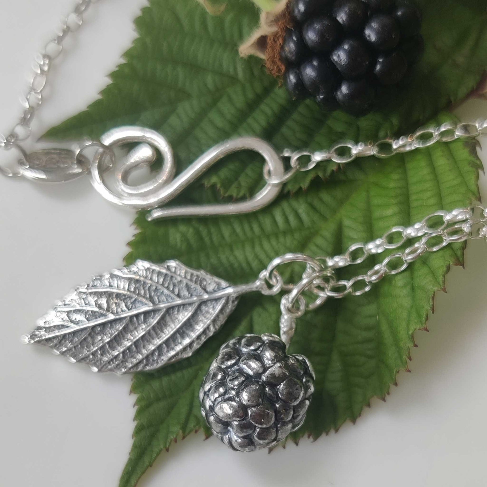 Blackberry and left necklace handcrafted in sterling silver. 