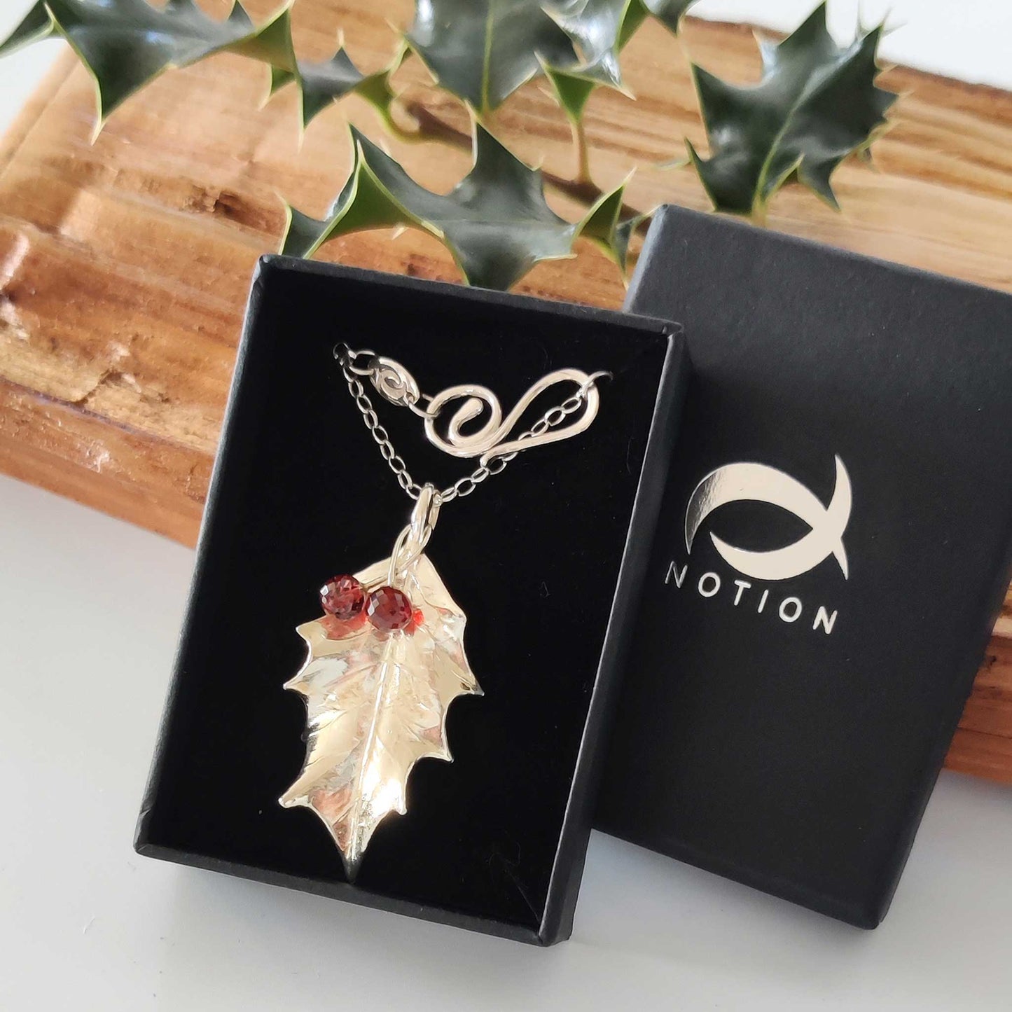 Boxed large silver holly leaf with Mozambique garnets
