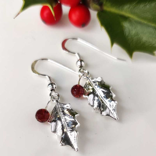 Silver holly drop earrings with garnets - front