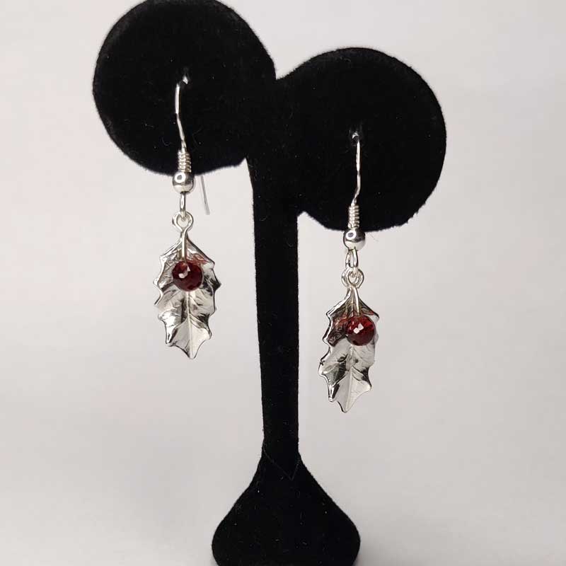 Silver holly drop earrings with garnets - stand