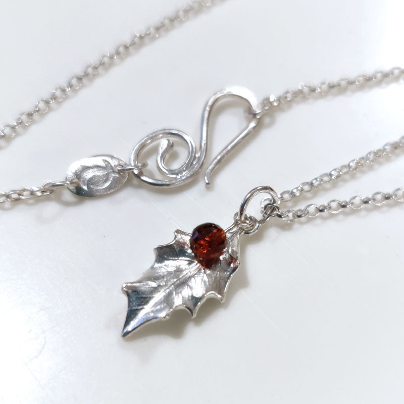 Tiny silver holly leaf with Mozambique garnets